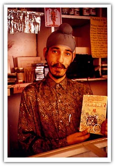 Book seller in Ladakh, India, with the english version of Obabakoak in his hands